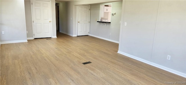 spare room featuring light hardwood / wood-style floors