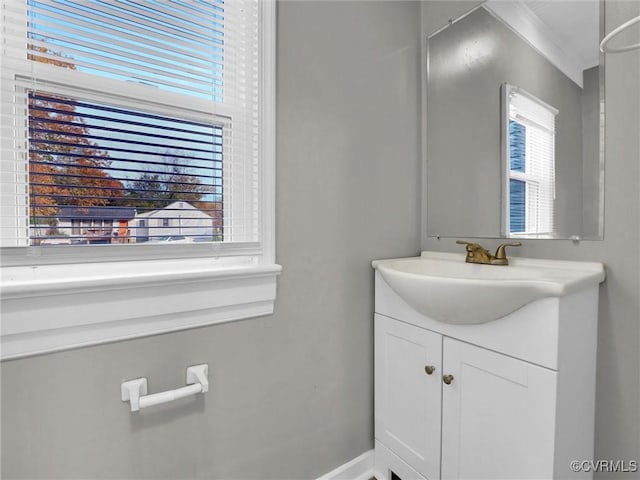 bathroom with vanity and ornamental molding