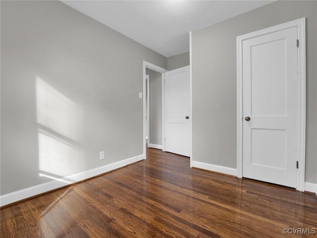 unfurnished bedroom with dark hardwood / wood-style floors