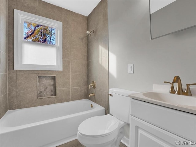 full bathroom with vanity, tiled shower / bath combo, and toilet