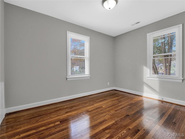 spare room with dark hardwood / wood-style flooring