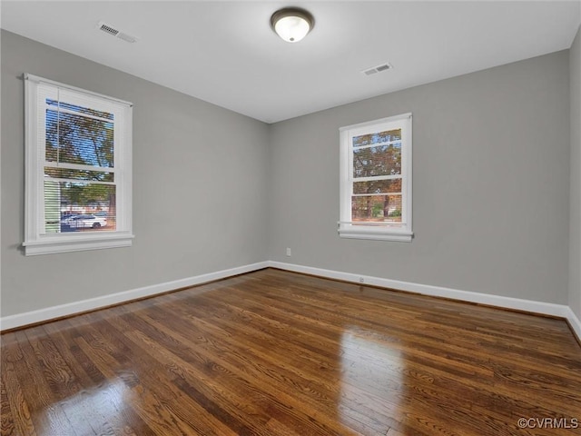 spare room with dark wood-type flooring