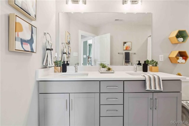 full bathroom with visible vents, a sink, and double vanity