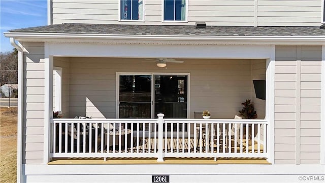 property entrance featuring roof with shingles and ceiling fan