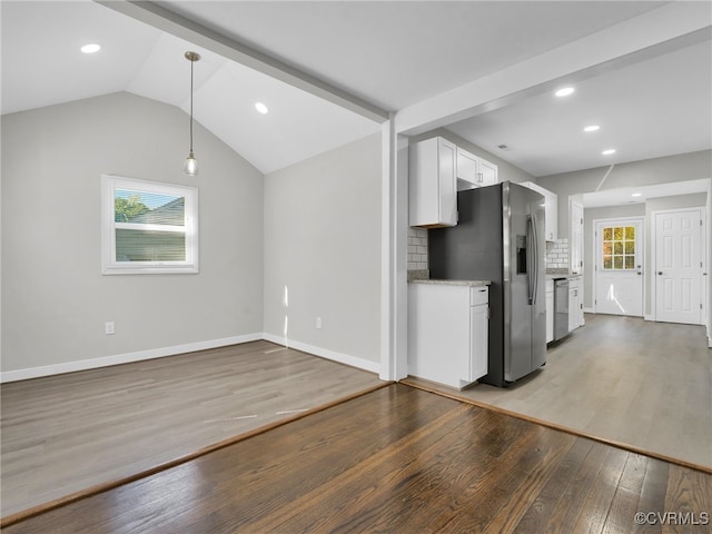 unfurnished living room with lofted ceiling and dark wood-type flooring