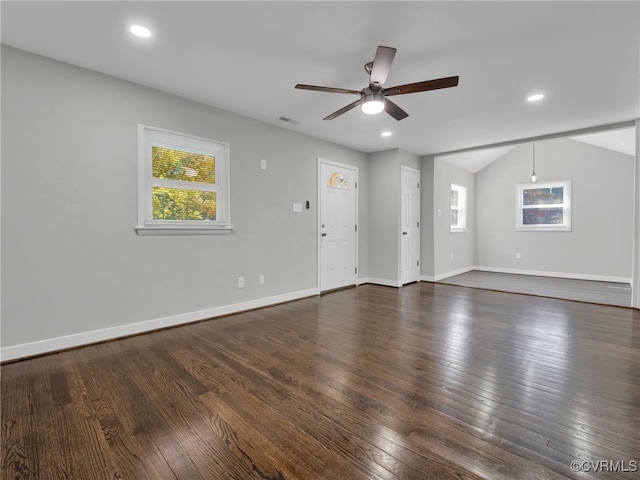 spare room with vaulted ceiling, dark wood-type flooring, and ceiling fan