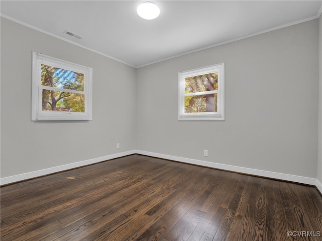 spare room featuring crown molding and dark hardwood / wood-style floors