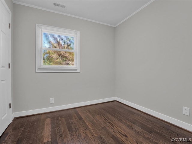 spare room with crown molding and dark wood-type flooring