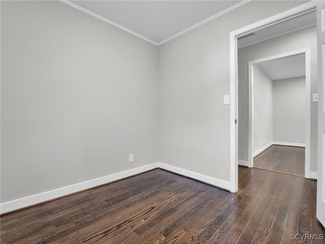 unfurnished room with crown molding and dark wood-type flooring