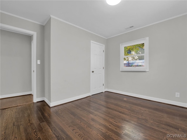 unfurnished room featuring crown molding and dark wood-type flooring