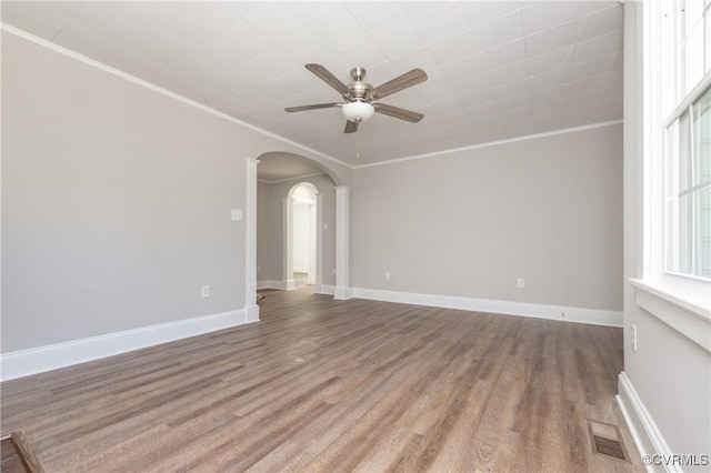 empty room featuring hardwood / wood-style floors, ceiling fan, and ornamental molding