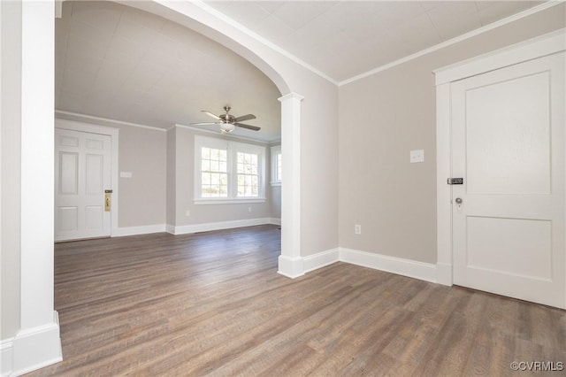 entrance foyer featuring ceiling fan, ornamental molding, and dark wood-type flooring