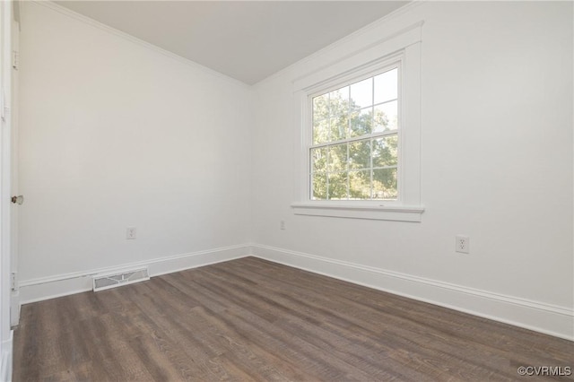 unfurnished room with dark hardwood / wood-style flooring and crown molding