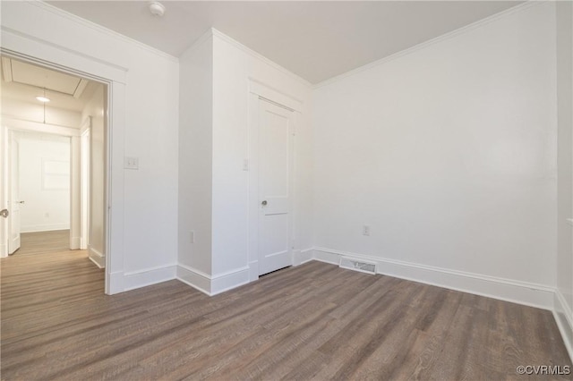 unfurnished room with dark wood-type flooring and ornamental molding