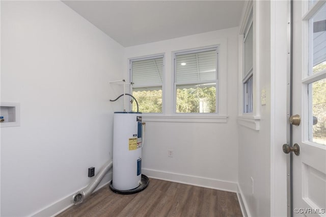 washroom with dark hardwood / wood-style floors and water heater