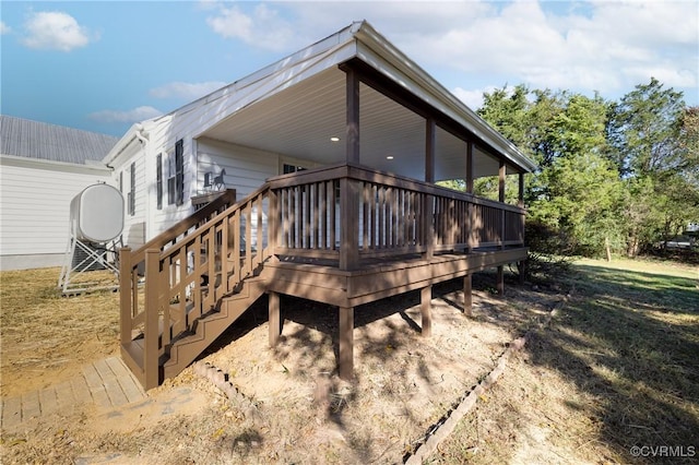 rear view of property featuring a deck