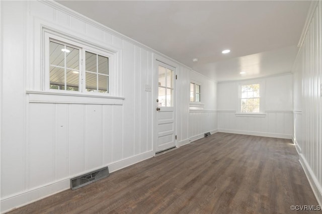 unfurnished room featuring dark hardwood / wood-style floors and ornamental molding