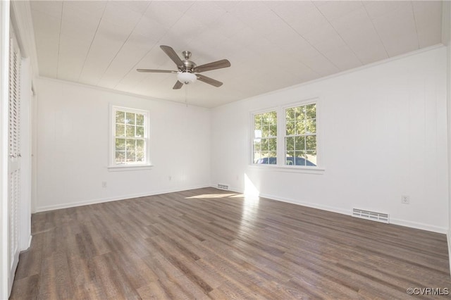 spare room featuring ceiling fan, dark hardwood / wood-style flooring, and crown molding