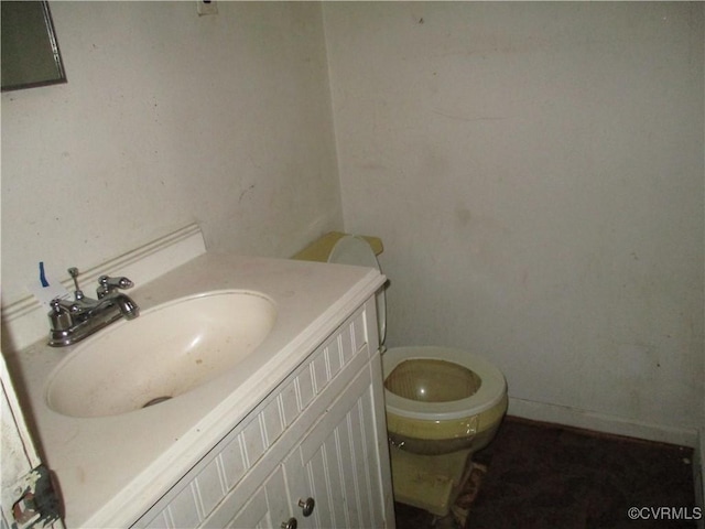 bathroom featuring vanity and toilet