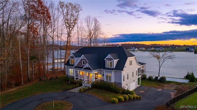 view of front of property with a water view and a garage