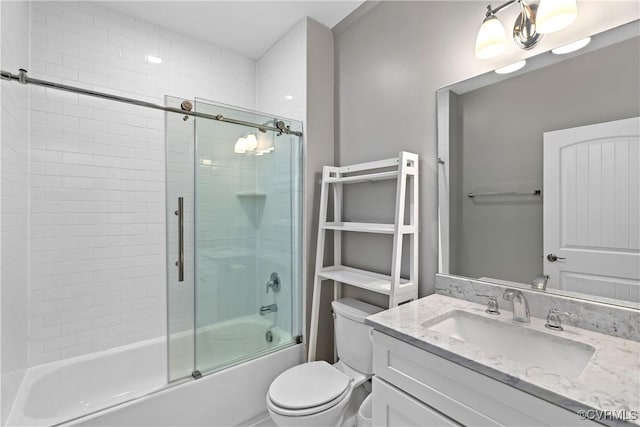 full bathroom with vanity, toilet, and enclosed tub / shower combo