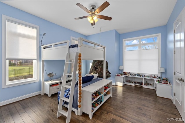 bedroom with ceiling fan and dark wood-type flooring