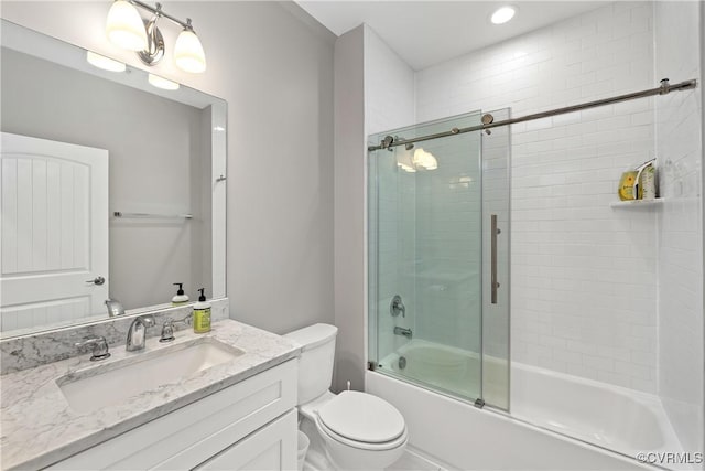 full bathroom with vanity, toilet, and bath / shower combo with glass door