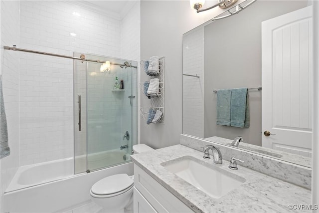 full bathroom featuring vanity, bath / shower combo with glass door, and toilet