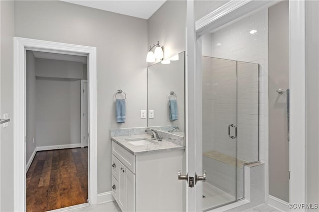 bathroom featuring vanity and a shower with shower door