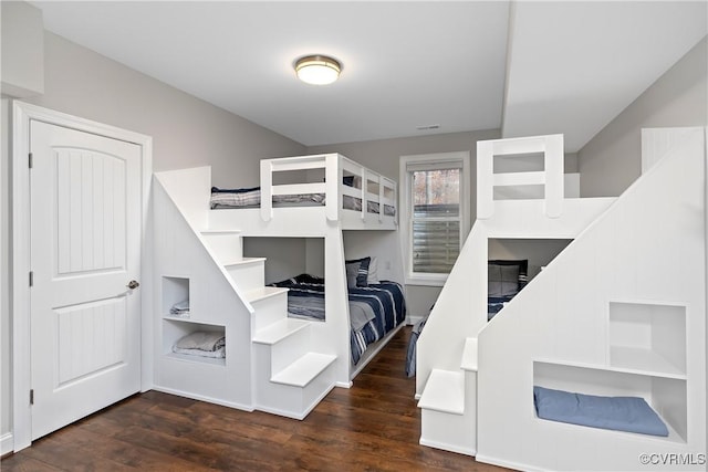 bedroom with dark hardwood / wood-style flooring