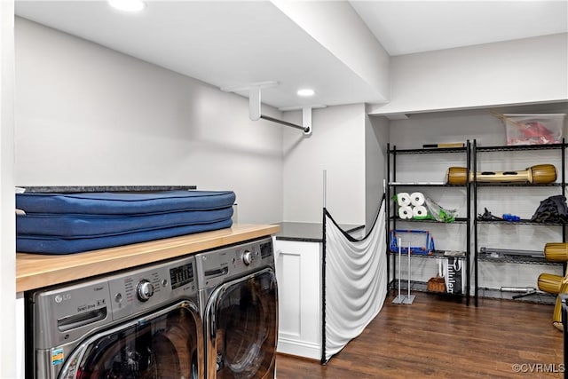 laundry area with dark hardwood / wood-style floors and washing machine and dryer