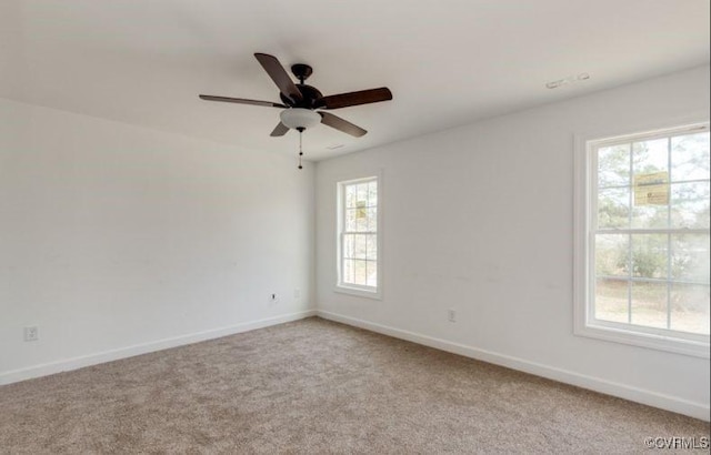 carpeted spare room featuring ceiling fan