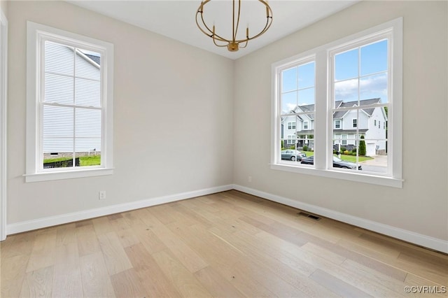 15812 W Millington Dr, Midlothian, VA 23112 - spare room featuring a chandelier, wood finished floors, and baseboards