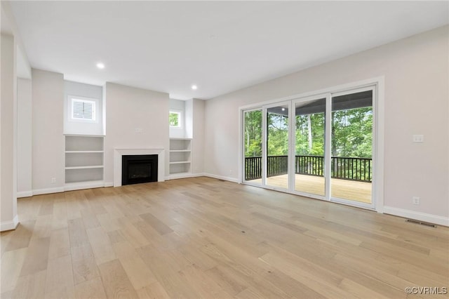 15812 W Millington Dr, Midlothian, VA 23112 - unfurnished living room featuring baseboards, light wood-style floors, recessed lighting, a fireplace, and built in features