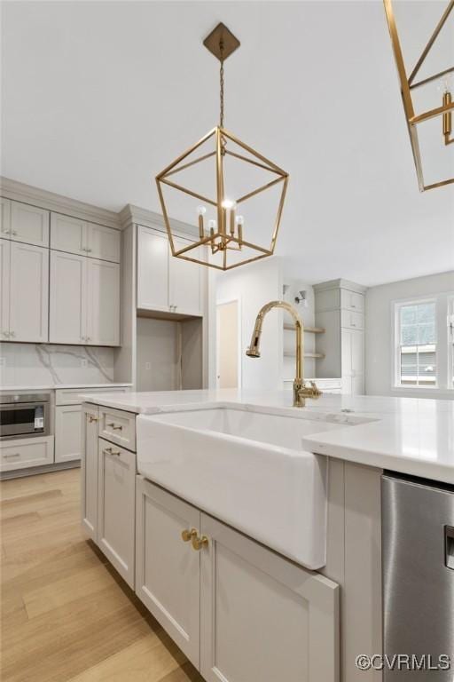 15812 W Millington Dr, Midlothian, VA 23112 - kitchen with a sink, a chandelier, light wood-style floors, hanging light fixtures, and refrigerator