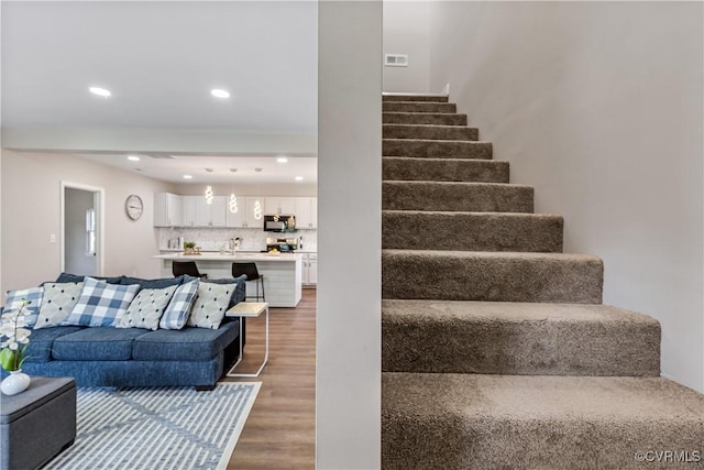 stairway featuring wood-type flooring