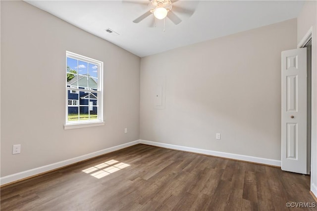 empty room with dark hardwood / wood-style floors and ceiling fan