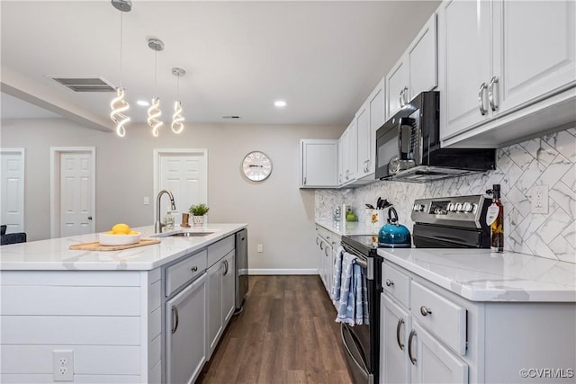 kitchen with backsplash, sink, stainless steel appliances, and decorative light fixtures