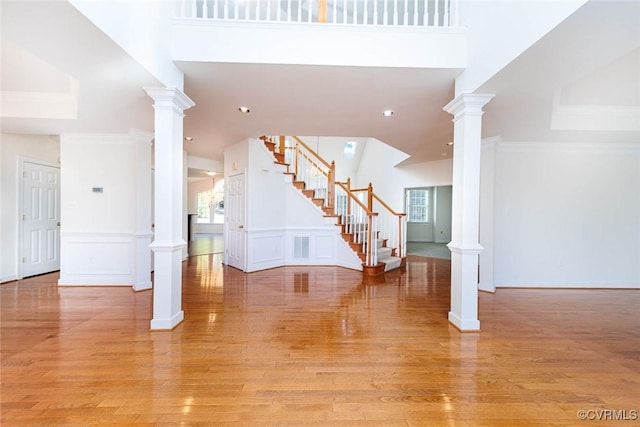 unfurnished living room with a wealth of natural light and light hardwood / wood-style flooring