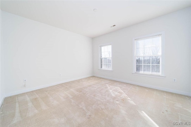 empty room featuring light carpet