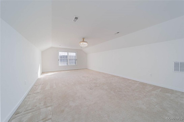 additional living space with light colored carpet and lofted ceiling