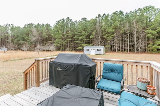 deck with a grill and a storage shed