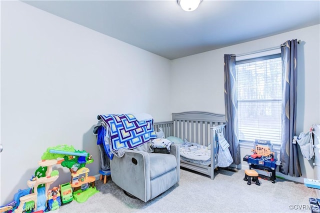 bedroom with light carpet and a crib