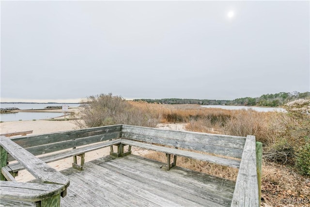 exterior space featuring a deck with water view