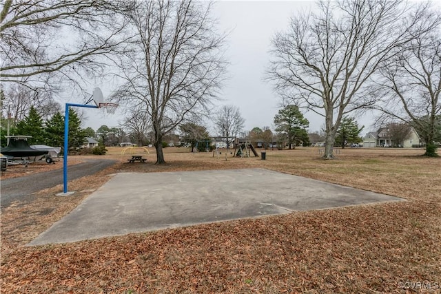 view of basketball court with a playground