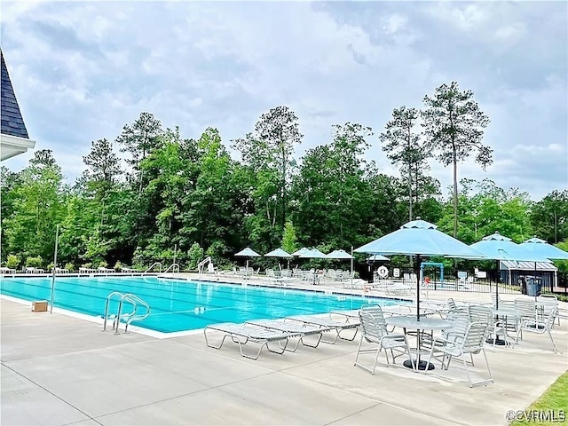 view of swimming pool with a patio area