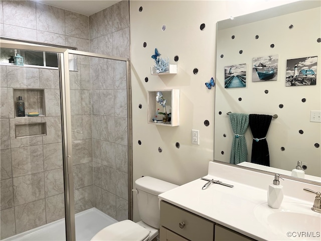 bathroom featuring vanity, toilet, and walk in shower