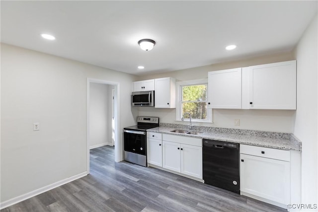 kitchen featuring white cabinets, sink, wood-type flooring, and stainless steel appliances