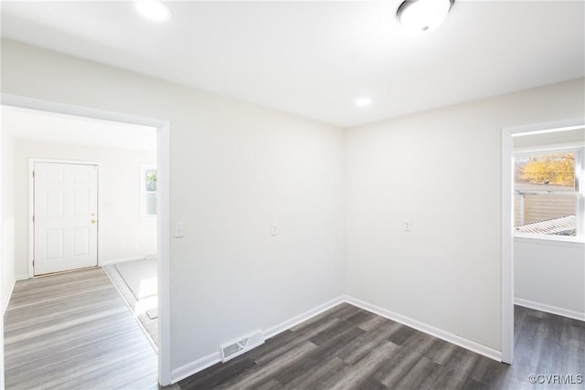 unfurnished room featuring dark wood-type flooring