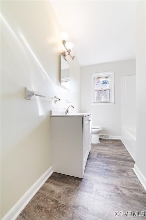 bathroom featuring hardwood / wood-style floors, vanity, and toilet